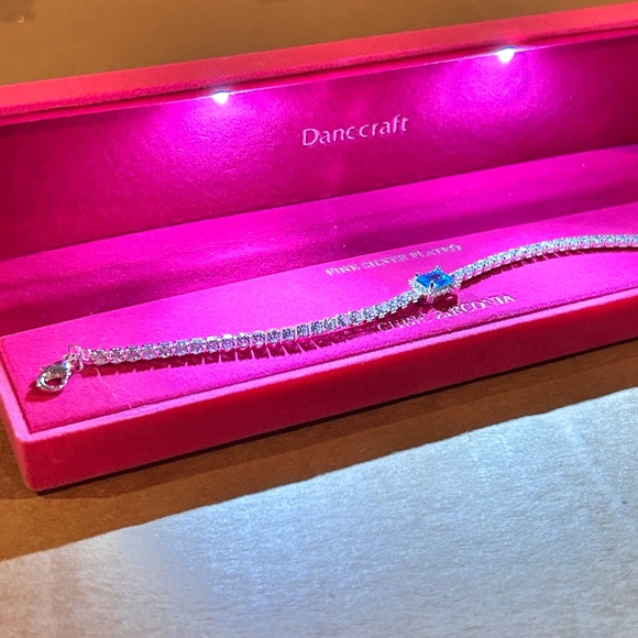 Danc Craft Silver Bracelet with CZ Sapphire Blue Accent
Stone.
New in Gift Box - Picture 3 of 3